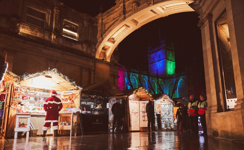 Bath Christmas Market stalls and tree lit up in green and blue